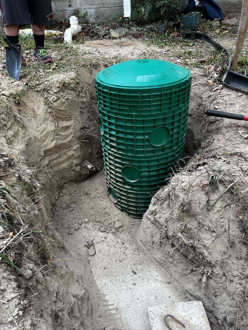 New septic tank riser being set over an open tank in Central Arkansas
